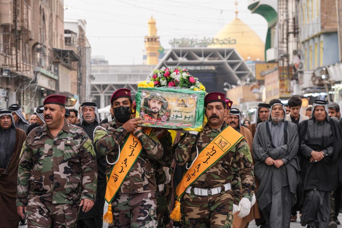 Mourners carry the coffin of a member of the pro-Iranian armed group Kataeb Hezbollah, who was killed in a reported US strike in Al-Qaim, during his funeral in Najaf on Mar.19, 2026. (AFP)