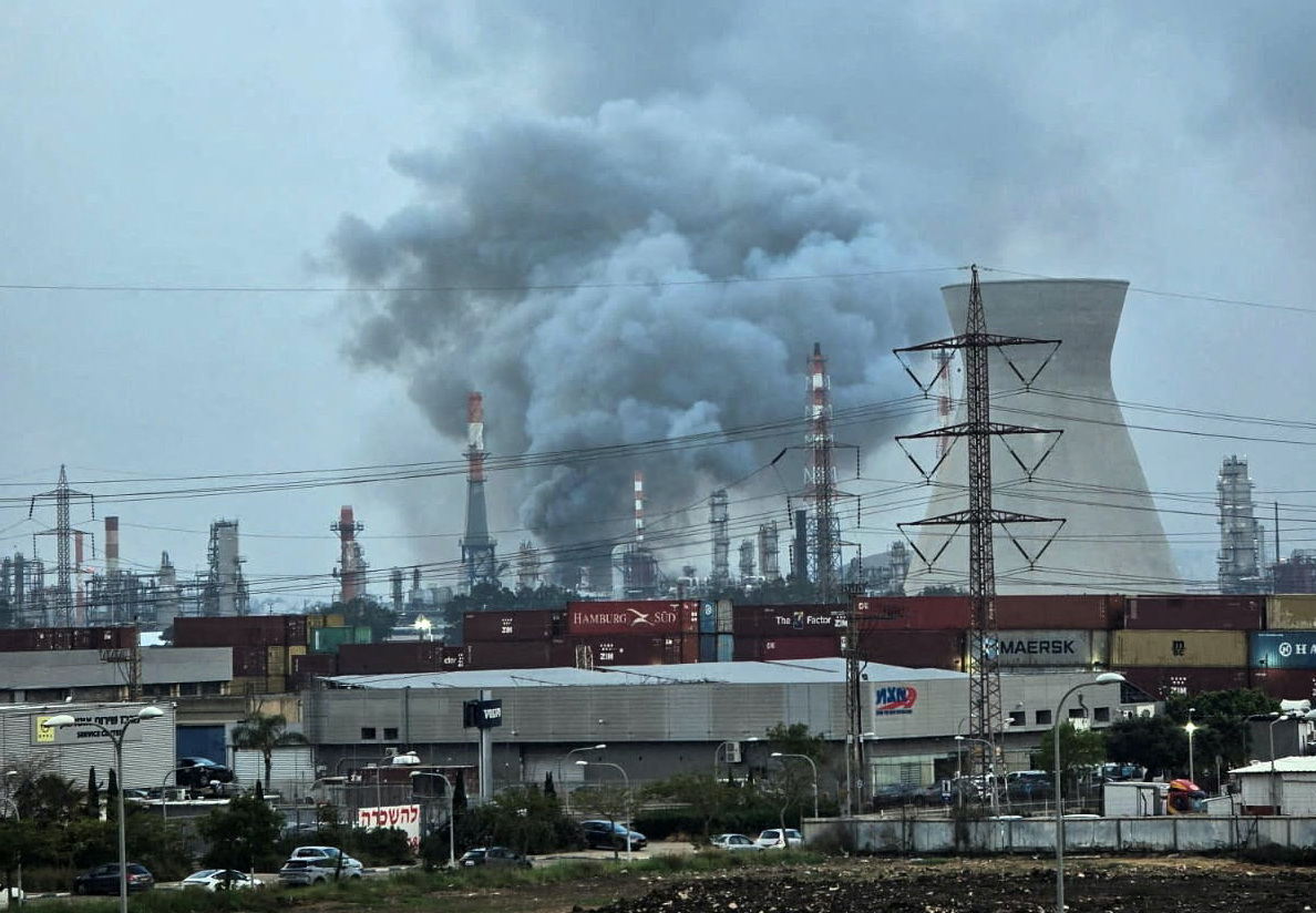 Smoke rises from an oil refinery damaged in an Iranian attack in Haifa, Israel on Thursday. (Reuters)