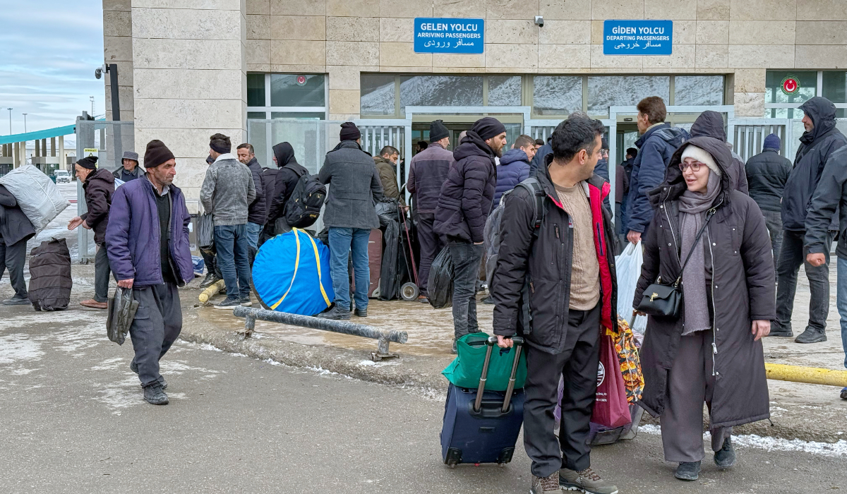 People, mostly Iranians, wait after crossing Kapikoy border post between Turkey and Iran, in Kapikoy, Turkey, Saturday, Jan. 17, 2026. (AP)