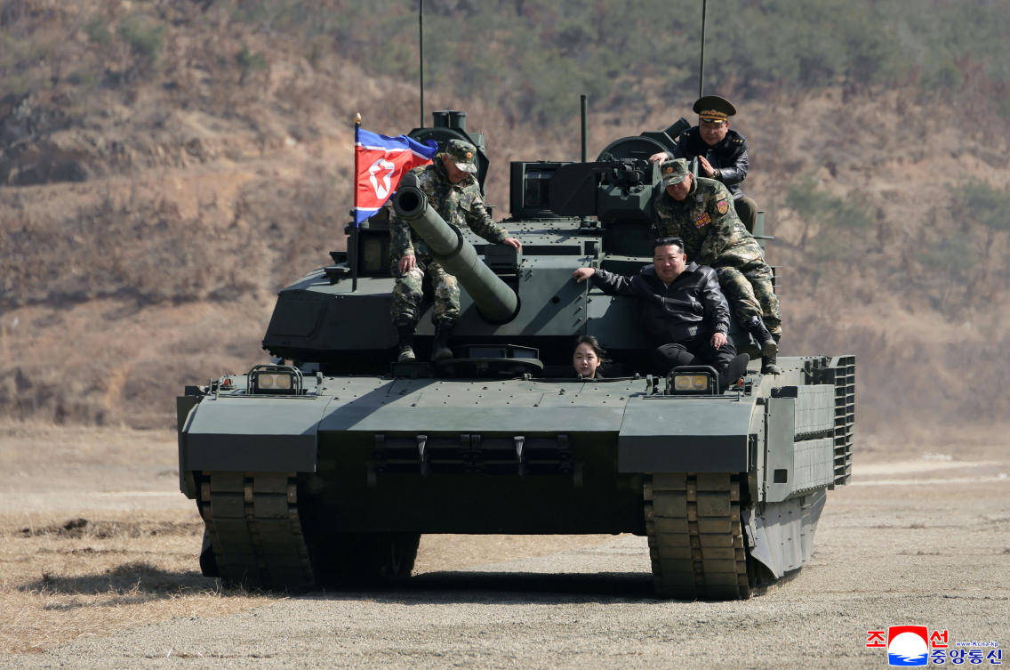 Kim Jong Un, front right, his daughter, reportedly named Kim Ju Ae, and other soldiers on a tank at a military training base in North Korea on March 19, 2026. (KCNA/KNS via AP)
