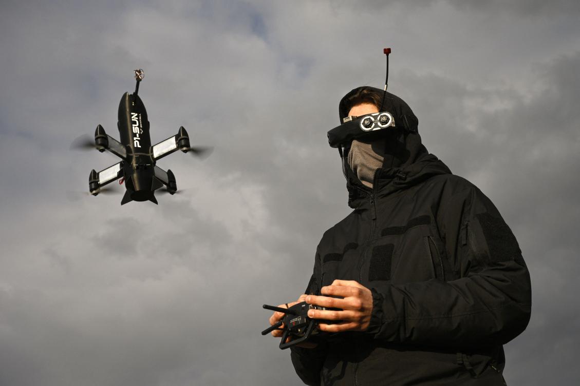 An employee of the Ukrainian SkyFall company conducts a test flight with a P1-Sun interceptor drone at an undisclosed location in Ukraine on Thursday. (AFP)