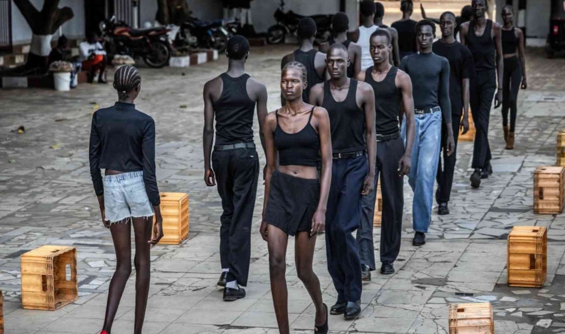 Heels click on cracked paving stones as fantastically long-limbed men and women practice moves they hope will whisk them away from South Sudan, one of the fashion world’s favorite scouting locations. (X/@TNXAfrica)