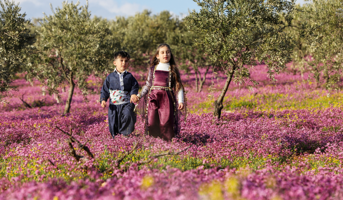 Syrian Kurd children hold each other's hands as they prepare to celebrate the spring festival of Nowruz, in Afrin, Syria, March 20, 2026. (REUTERS)