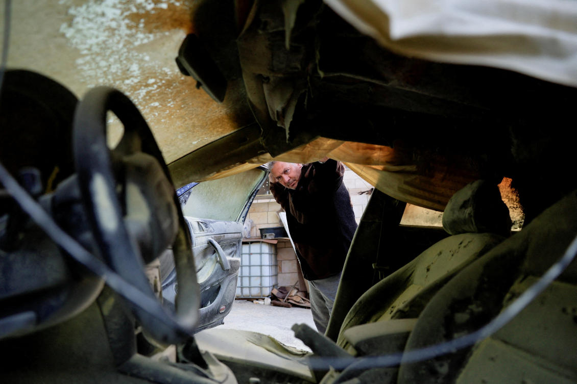 A man checks a damaged car, which Palestinians say was burned by Israeli settlers, in Hebron in the Israeli-occupied West Bank Mar. 19, 2026. (Reuters)