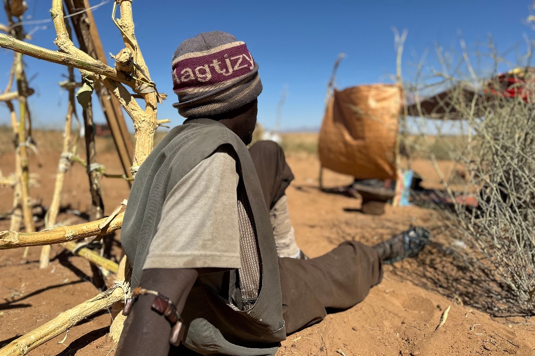 Sudanese displaced Abdullah Idris, who says he was imprisoned and tortured in Rapid Support Forces' (RSF) prisons before fleeing El-Fasher, sits at a makeshift shelter in the town of Tawila, Sudan. (AFP)