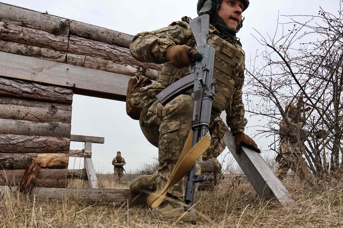 This handout photograph taken and released by the press service of the 65th Mechanized Brigade of Ukrainian Armed Forces shows Ukrainian recruits completing basic military training at an undisclosed location in Zaporizhzhia region.