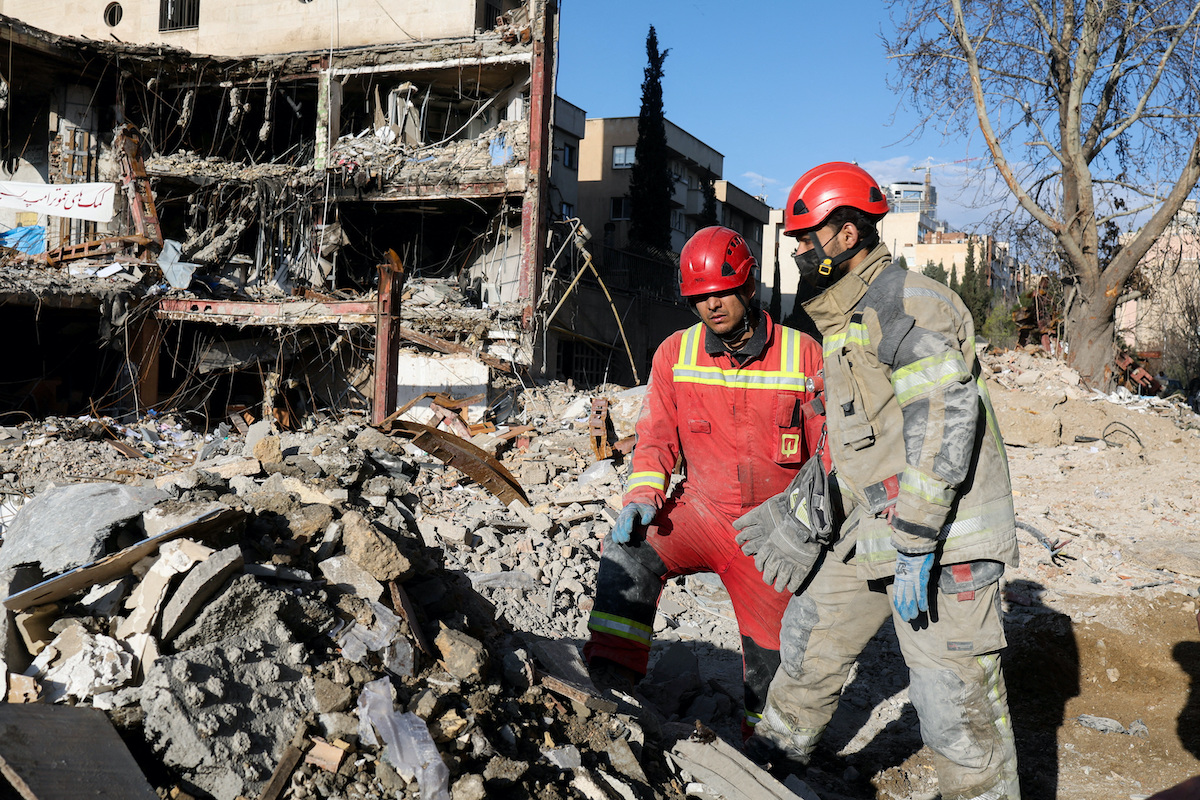 Red Crescent rescue teams at a building damaged by a strike in Tehran on Saturday. (Reuters)