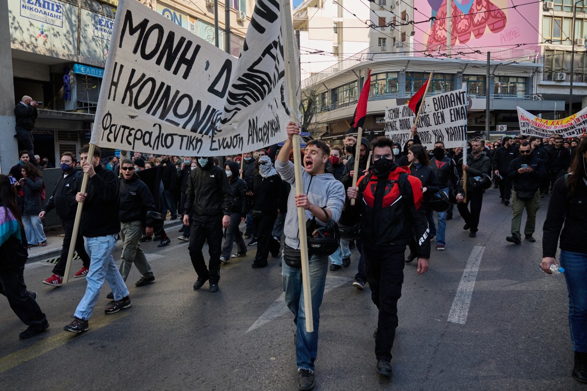 People take part in a demonstration outside the Greek parliament, marking the third anniversary of the Tempi train crash that killed 57 people in Athens, Greece. (AFP)