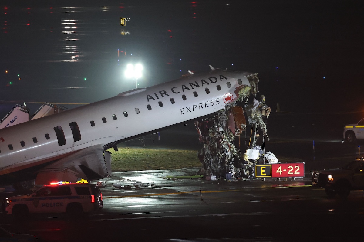 Above, an Air Canada Express CRJ-900 sits on the runway after colliding with a Port Authority fire truck at LaGuardia Airport in New York on March 23, 2026. (AFP)