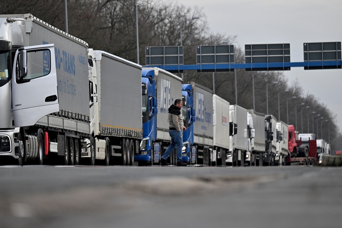 A truck driver crosses a road at the Batrovci border crossing between Serbia and Croatia. (AFP)