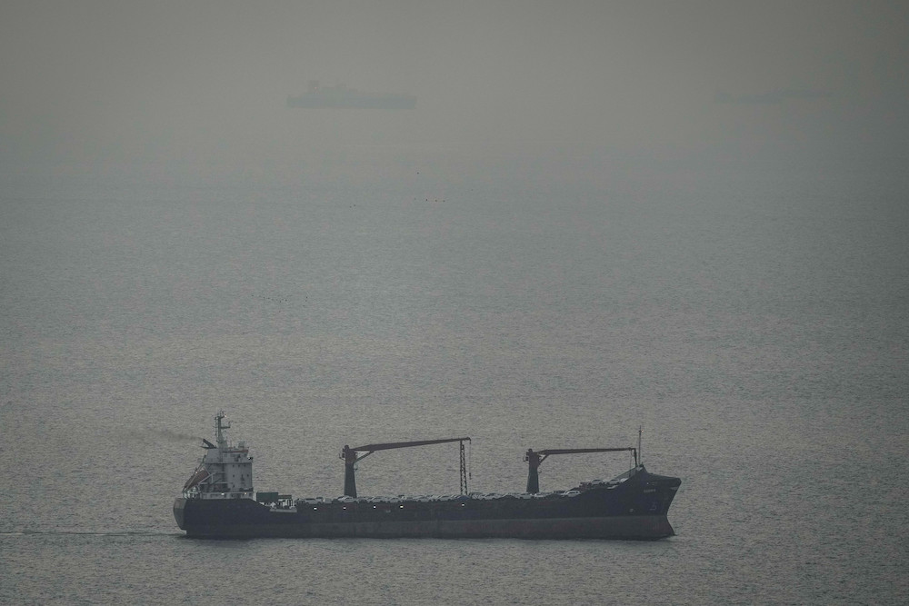 A cargo ship carrying vehicles sails through the Arabian Gulf toward the Strait of Hormuz in the United Arab Emirates, Sunday, March 22, 2026. (AP)
