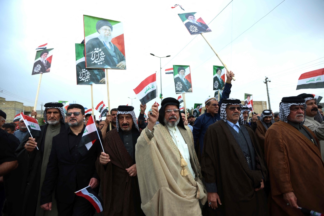 Waving the Iraqi flag and holding up placards with the image of the assassinated Iranian supreme leader Ayatollah Ali Khamenei, Iraqis rally in support of neighbouring Iran, in the al-Aamil district of Baghdad, Iraq. (AFP)