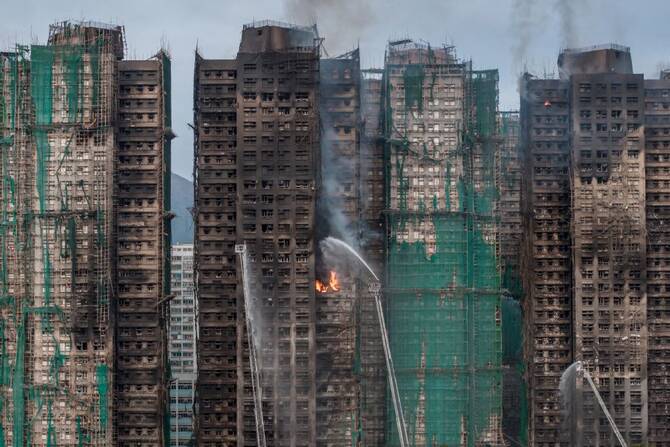 Survivors who escaped the massive blaze that killed 168 people at a Hong Kong housing estate last year told a public hearing Tuesday they still blame themselves for failing to save their neighbors. (AFP/File)