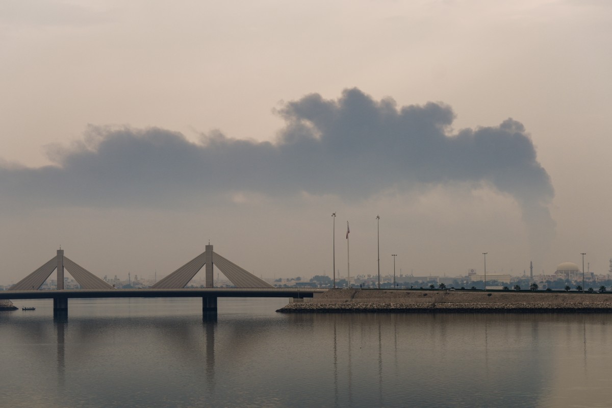 A plume of smoke rises after a reported Iranian strike on fuel tanks in Muharraq, Bahrain, March 12, 2026. (AFP)