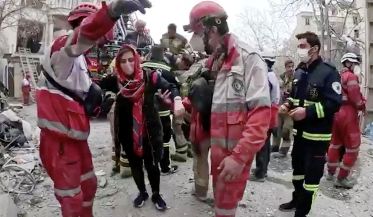 A woman is helped by emergency personnel following a reported strike, amid the U.S.-Israeli conflict with Iran, in Tehran, Iran, in this screengrab from video released on March 23, 2026. (REUTERS)