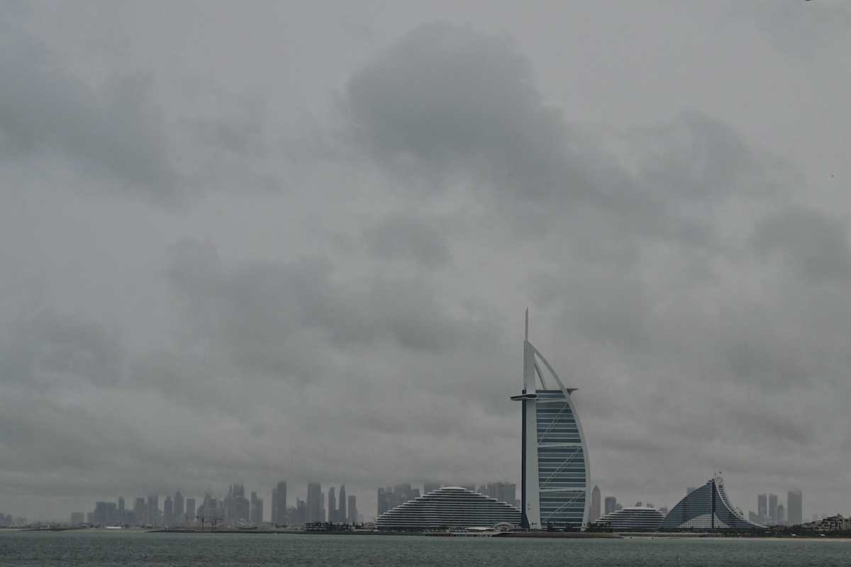 Thick clouds fill the sky above the Burj Al-Arab tower in Dubai on May 2, 2024, as heavy rains returned to the United Arab Emirates just two weeks after record downpours that experts linked to climate change. (FILE/AFP)