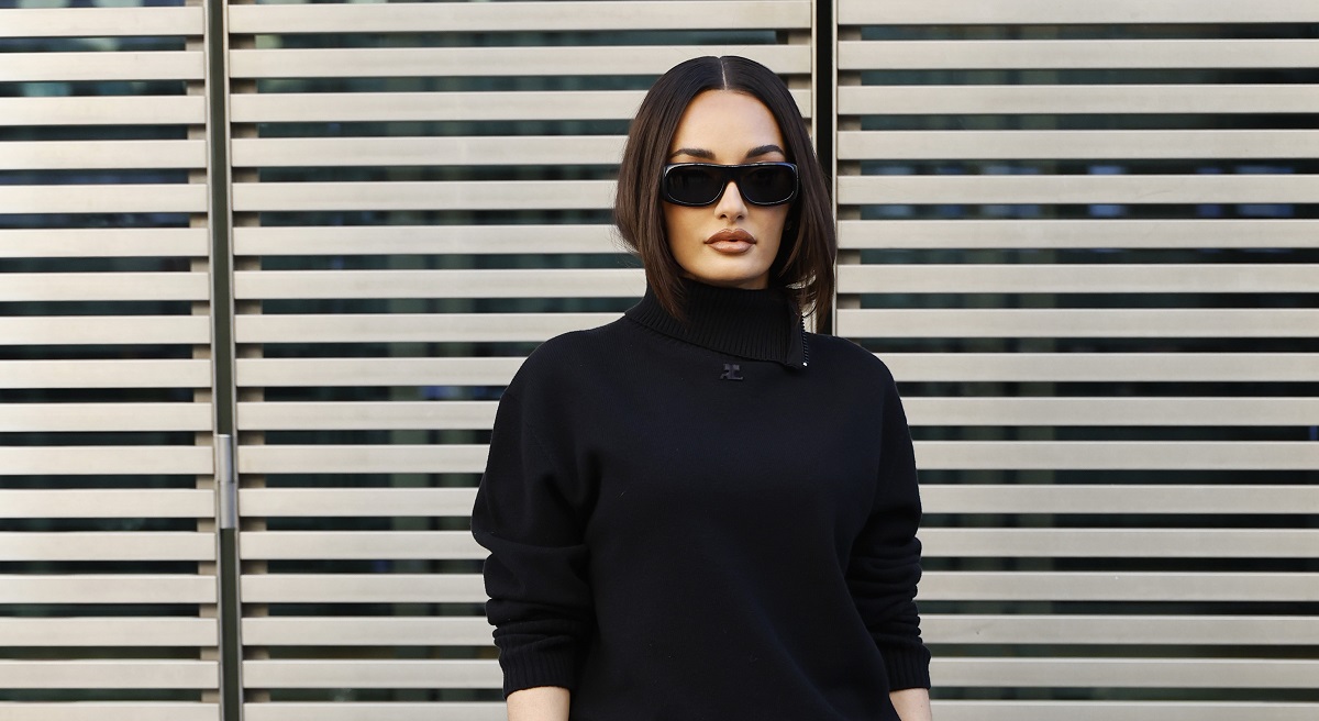 Amina Muaddi wears black Courreges turtleneck jumper outside the Courreges show at Paris Fashion Week on March 4. (Getty Images)