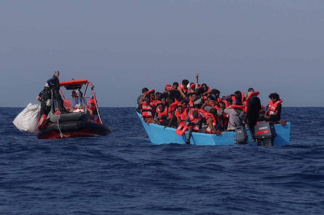 Migrants aboard an overcrowded boat react as they are approached by the crew of the migrant search and rescue ship Sea-Watch 5, during a rescue operation in the Search and Rescue zone in the central Mediterranean, off Libya. (Reuters)