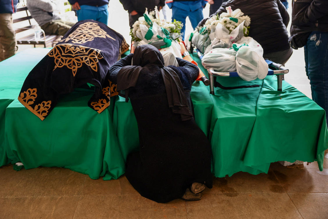 The mother of one of two paramedics killed by an Israeli strike, mourns over a body, amid escalating hostilities between Israel and Hezbollah, as the US-Israeli conflict with Iran continues, in Nabatieh, Lebanon, Mar. 25, 2026. (Reuters)