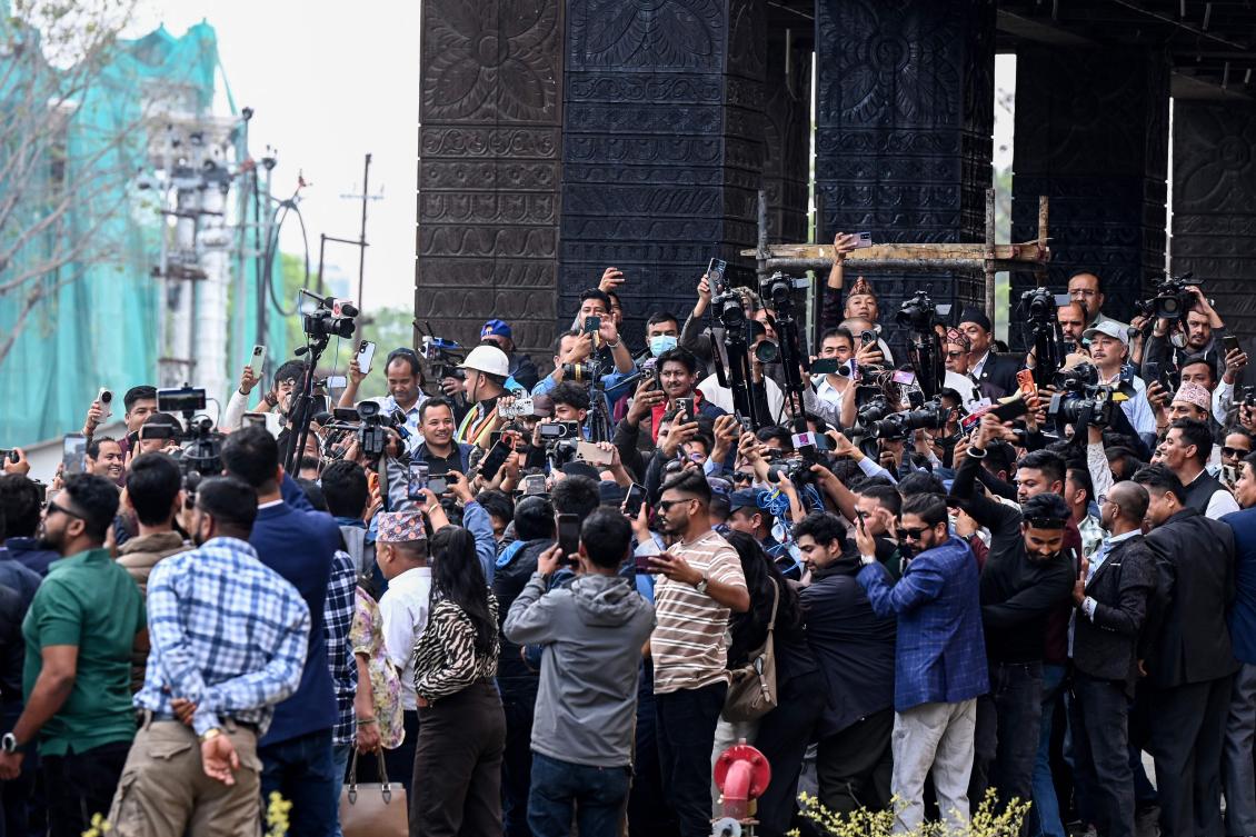 Journalists surround Rastriya Swatantra Party (RSP) leader Balendra Shah as he arrives to take the oath during a swearing-in ceremony at the parliament in Katmandu on March 26, 2026. (AFP)