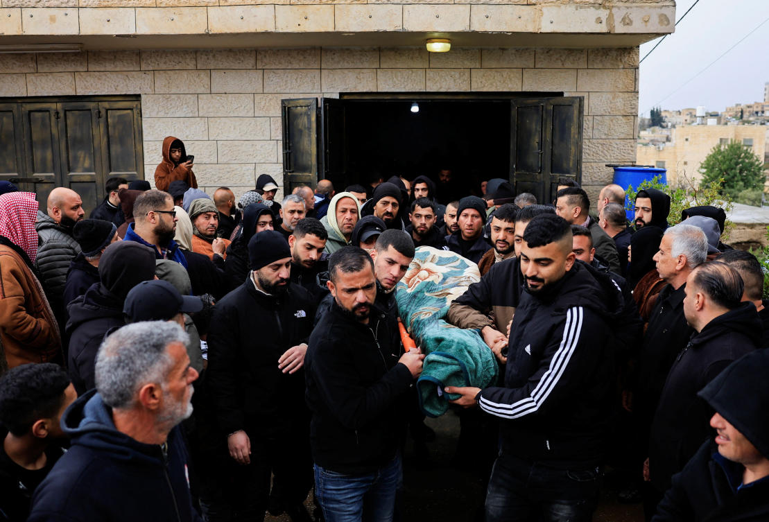 Mourners carry the body of Yosri Abu Qbiatah, a 31-year-old Palestinian who was killed by Israeli forces, according to the Palestinian health ministry, during his funeral in Yatta near Hebron, in the Israeli-occupied West Bank Mar. 26, 2026. (Reuters)