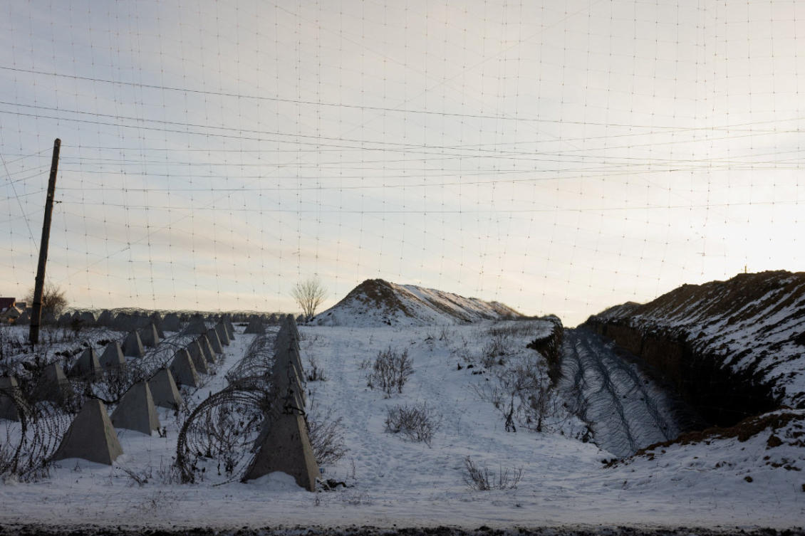 This photograph shows Dragon's Teeth (pyramidal anti-tank obstacles made from reinforced concrete) and coils of barbed wire as part of defense fortifications in a field at an undisclosed location in eastern Ukraine on January 19, 2026, amid the Russian invasion of Ukraine. (AFP)