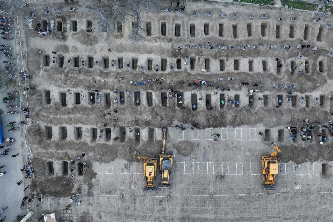 In this aerial handout picture released by the Iranian Press Center, mourners dig graves during the funeral for children killed in a reported strike on a primary school in Iran’s Hormozgan province in Minab on March 3, 2026. (FILE/AFP)