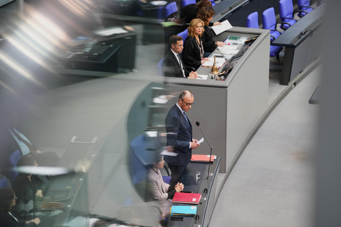 German Chancellor Friedrich Merz, center, speaks during a Q&A at the German parliament Bundestag in Berlin, Germany, Wednesday, March 25, 2026. (AP Photo/Markus Schreiber)