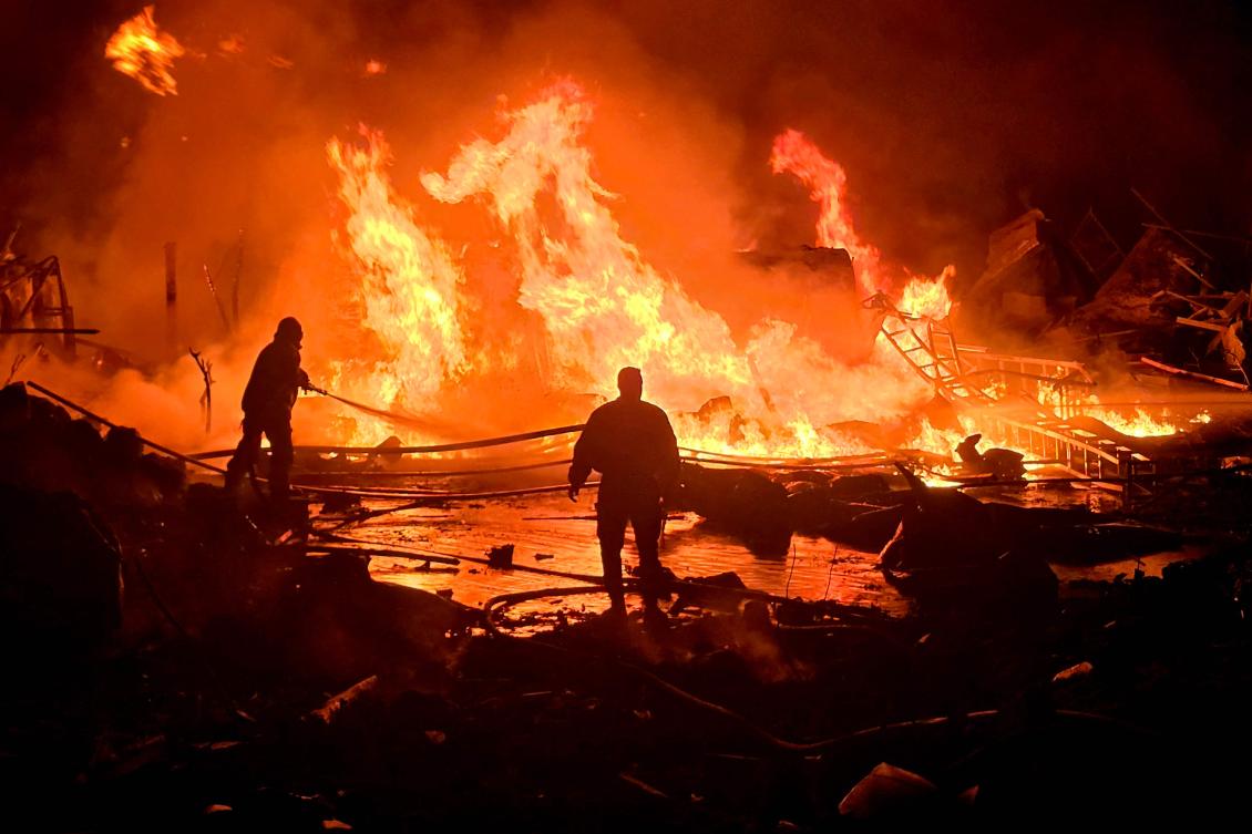 Civil defense teams tackle a blaze that erupted after Israeli bombardment of a solar farm and electricity generation facility in Tyre Lebanon on March 4. G7 countries called for an end to attacks on civilian infrastructure. (AFP)