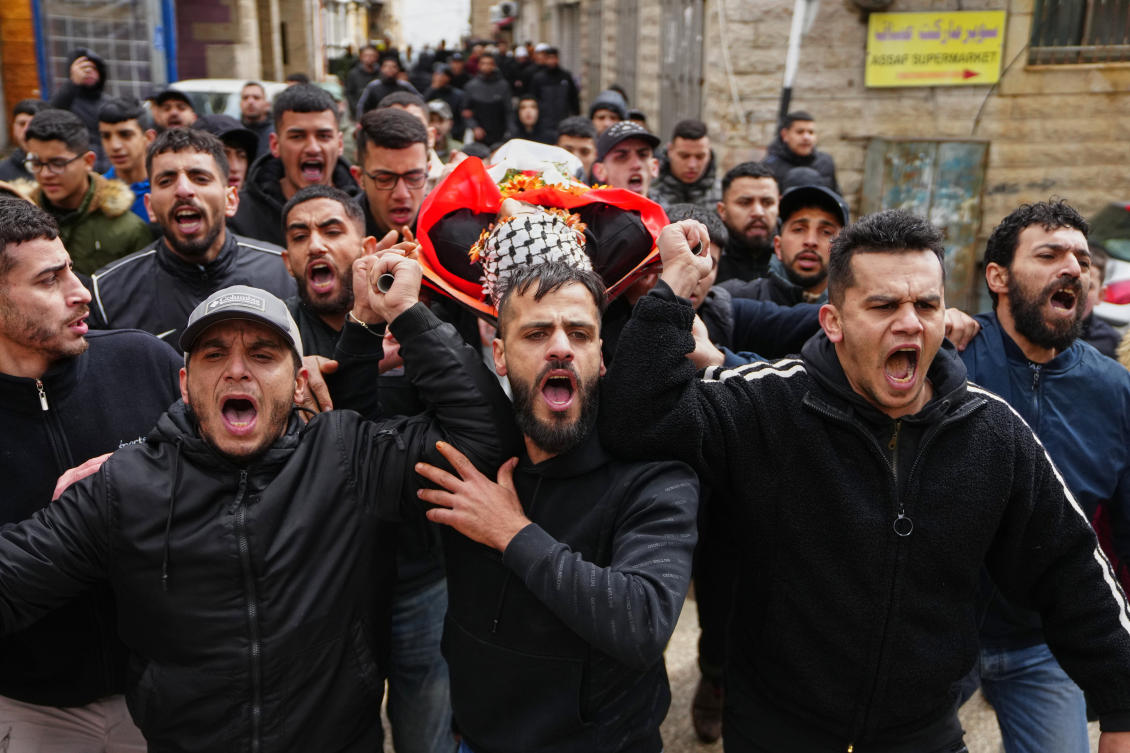 Mourners carry the body of Palestinian Mustafa Hamad, 22, during his funeral in the occupied West Bank refugee camp of Qalandia on Friday. (AP)