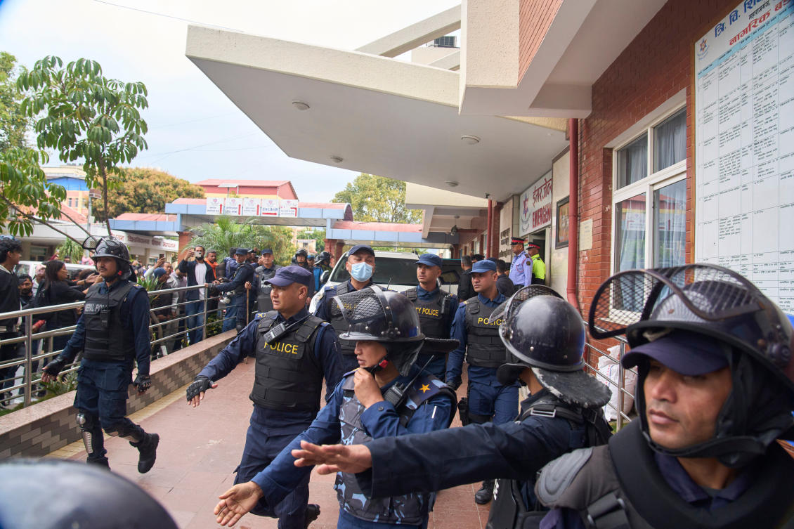 Nepalese policemen clear the street as former Prime Minister Khadga Prasad Oli is taken for procedural medical checkup after he was arrested by police over September protest deaths in Kathmandu, Nepal, Saturday, March 28, 2026. (AP)