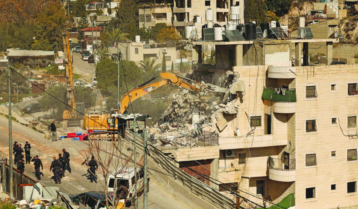 Israeli security forces gather as excavators demolish a building constructed without a permit in the Wadi Qaddum area near the Silwan neighbourhood of east Jerusalem on December 22, 2025. (AFP file photo)