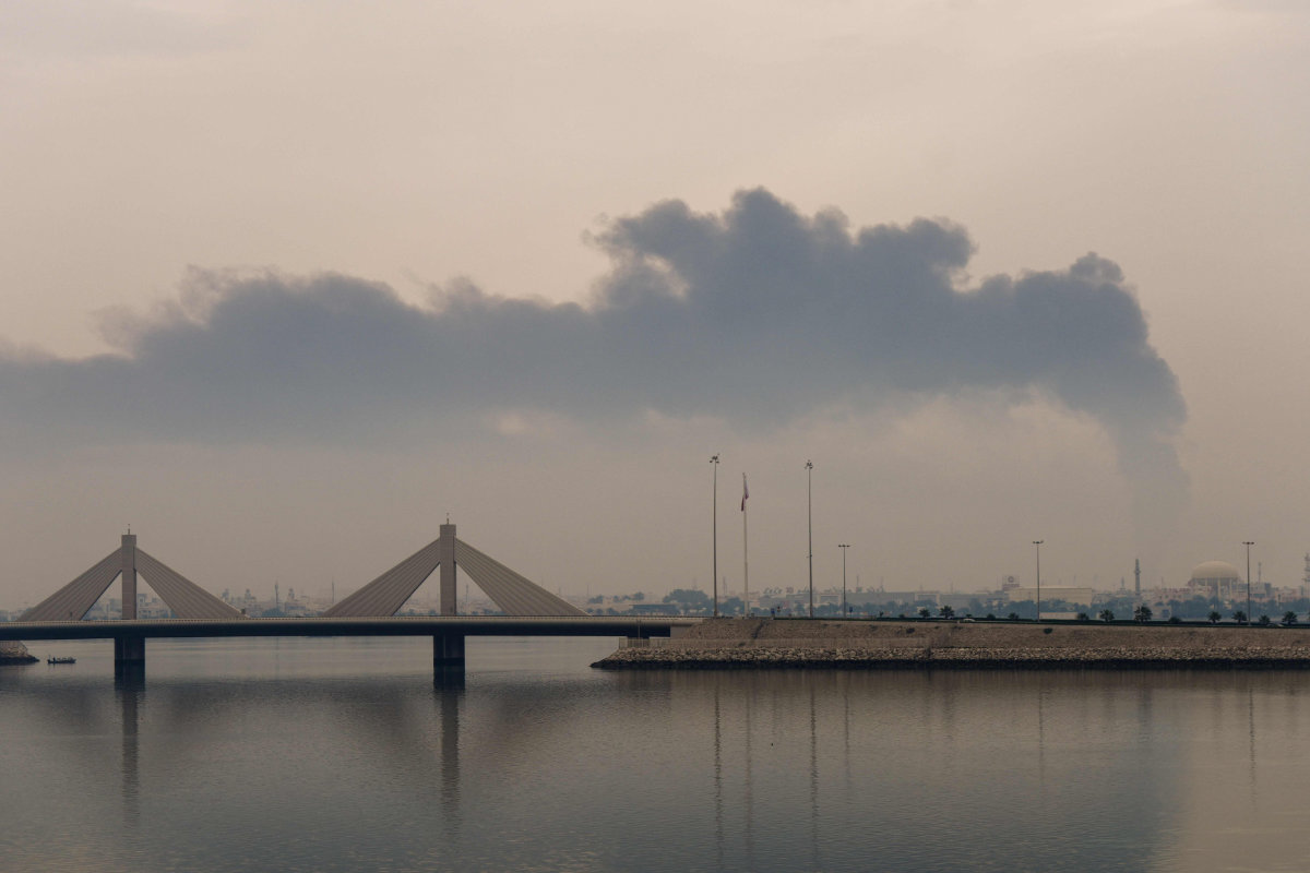 A plume of smoke rises after an Iranian strike on fuel tanks in Muharraq, Bahrain, on March 12, 2026. (AFP)
