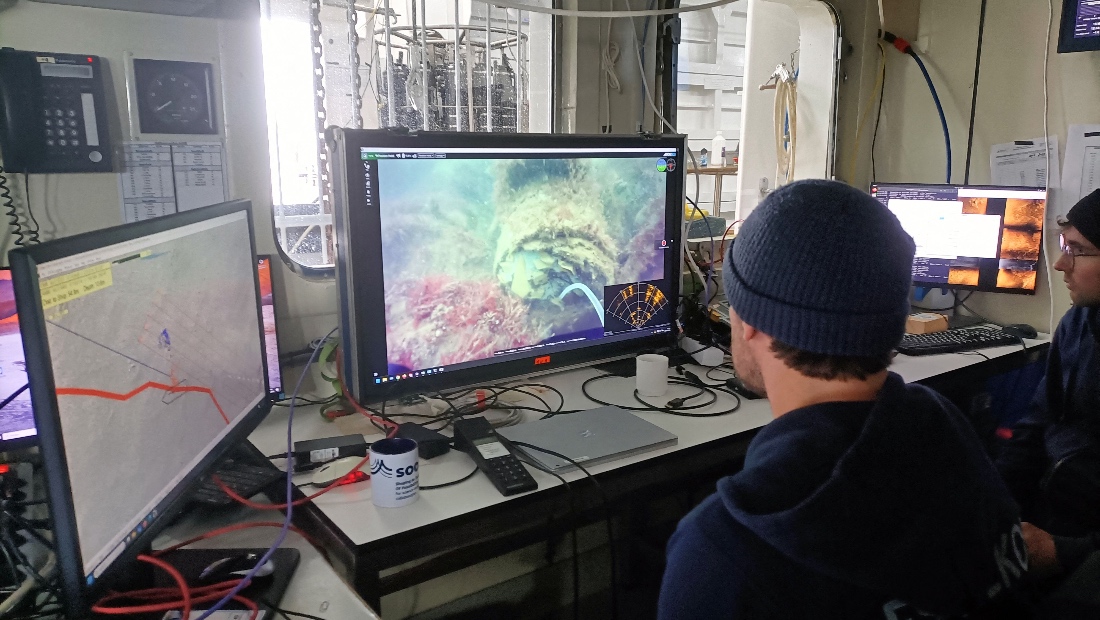 Scientists looking at footage of munition on the seabed, aboard the scientific research vessel Alkor, belonging to the Kiel-based GEOMAR oceanographic research centre, undefined location. (AFP)