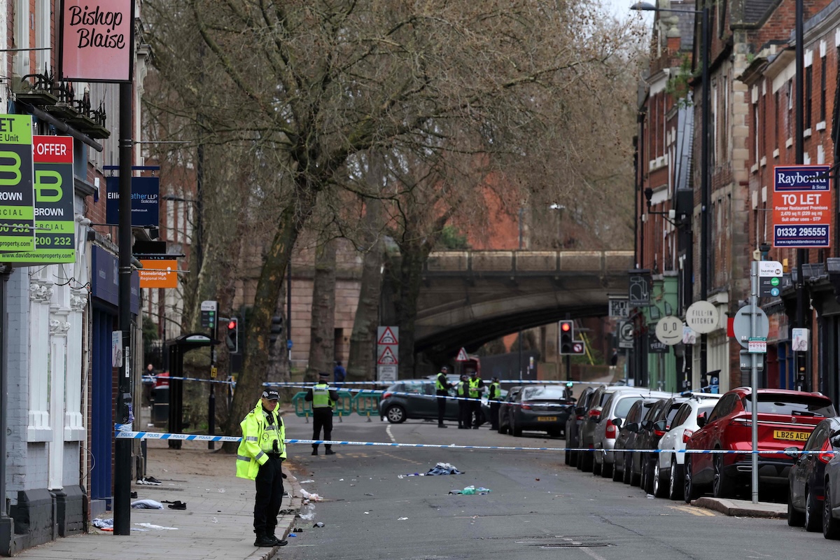 Police officers work near a cordon set up on Friar Gate in central Derby, central England on March 29, 2026, following an incident the night before where was vehicle has driven into pedestrians. (AFP)