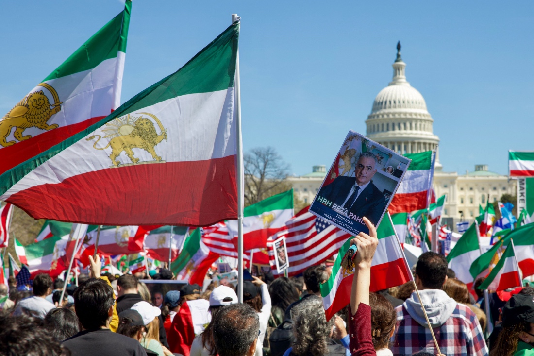 Demonstrators wave Iranian pre-1979 Islamic Revolution flags and hold up an image of Reza Pahlavi, son of the last shah of Iran, near Washington DC, US. (AFP)