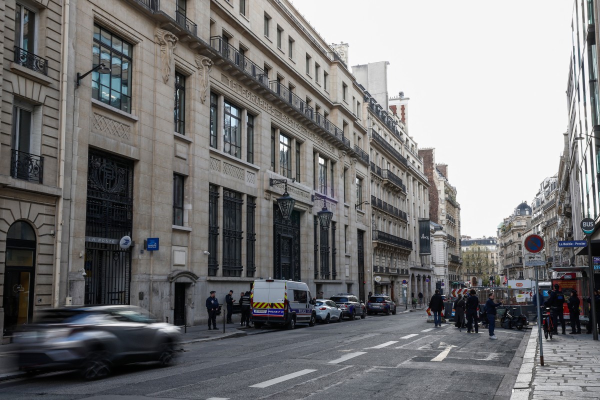 The Bank of America building with police and private security vehicles in Paris, France. (AFP)