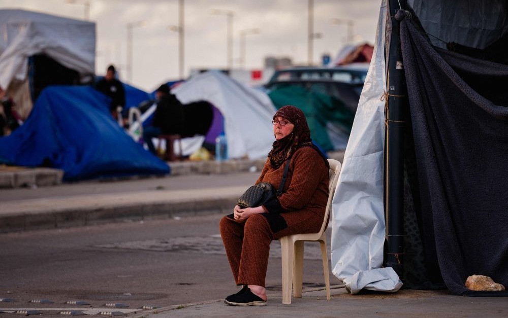 A displaced Lebanese woman sits in front of her tent on Beirut’s waterfront, Mar. 30, 2026. (AFP)