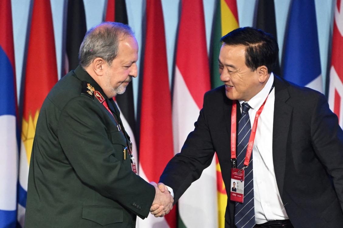 Iran’s Deputy Defence Minister Majid Ebnoreza (L) shakes hands with China’s former defence attache to the USA Zhang Li after speaking during a plenary session of the Xiangshan Forum in Beijing on September 19, 2025. (File/AFP)