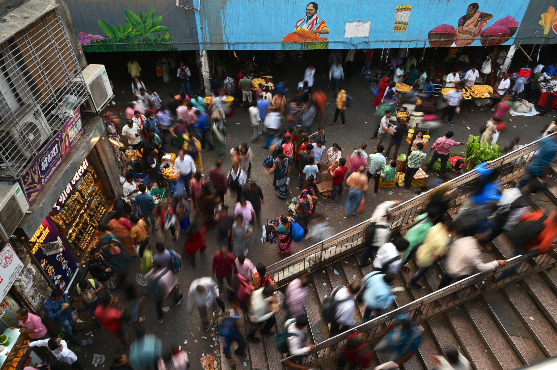Commuters climb a foot over bridge outside a railway station in Mumbai, India. (AFP)
