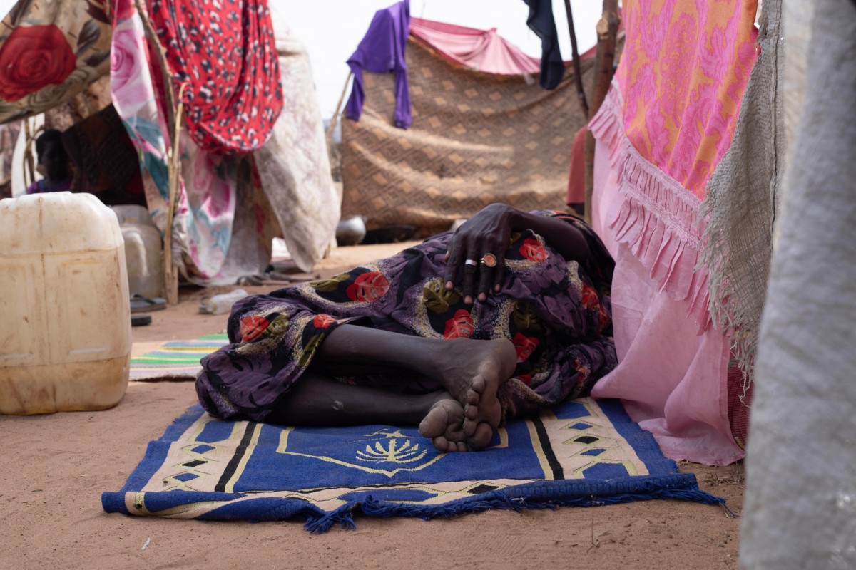 A displaced Sudanese who fled El-Fasher rests on a mat in the camp of Um Yanqur, located on the southwestern edge of Tawila, in Darfur region. (AFP)