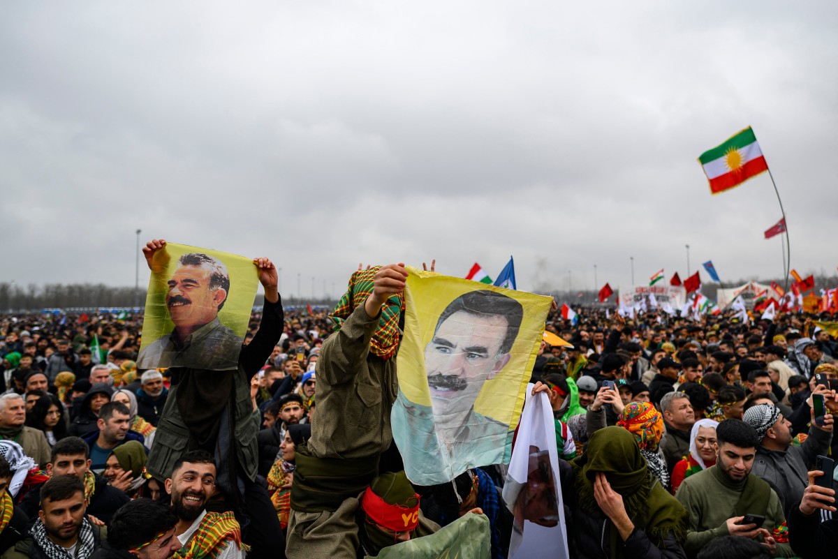 Members of the Kurdish community hold portraits of Abdullah Ocalan,during a Kurdish celebration of the Nowruz in Istanbul, Turkiye. (AFP)