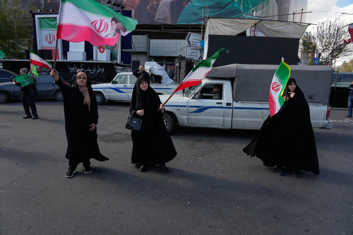 Above, pro-government campaigners wave Iranian flags at the Enqelab-e-Eslami square in downtown Tehran on March 30, 2026. (AP)