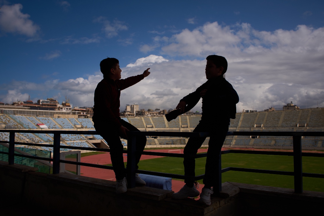 Displaced children talk inside Camille Chamoun Sports City Stadium, now used as a shelter for people displaced by Israeli airstrikes in southern Lebanon, in Beirut, Lebanon. (AP)