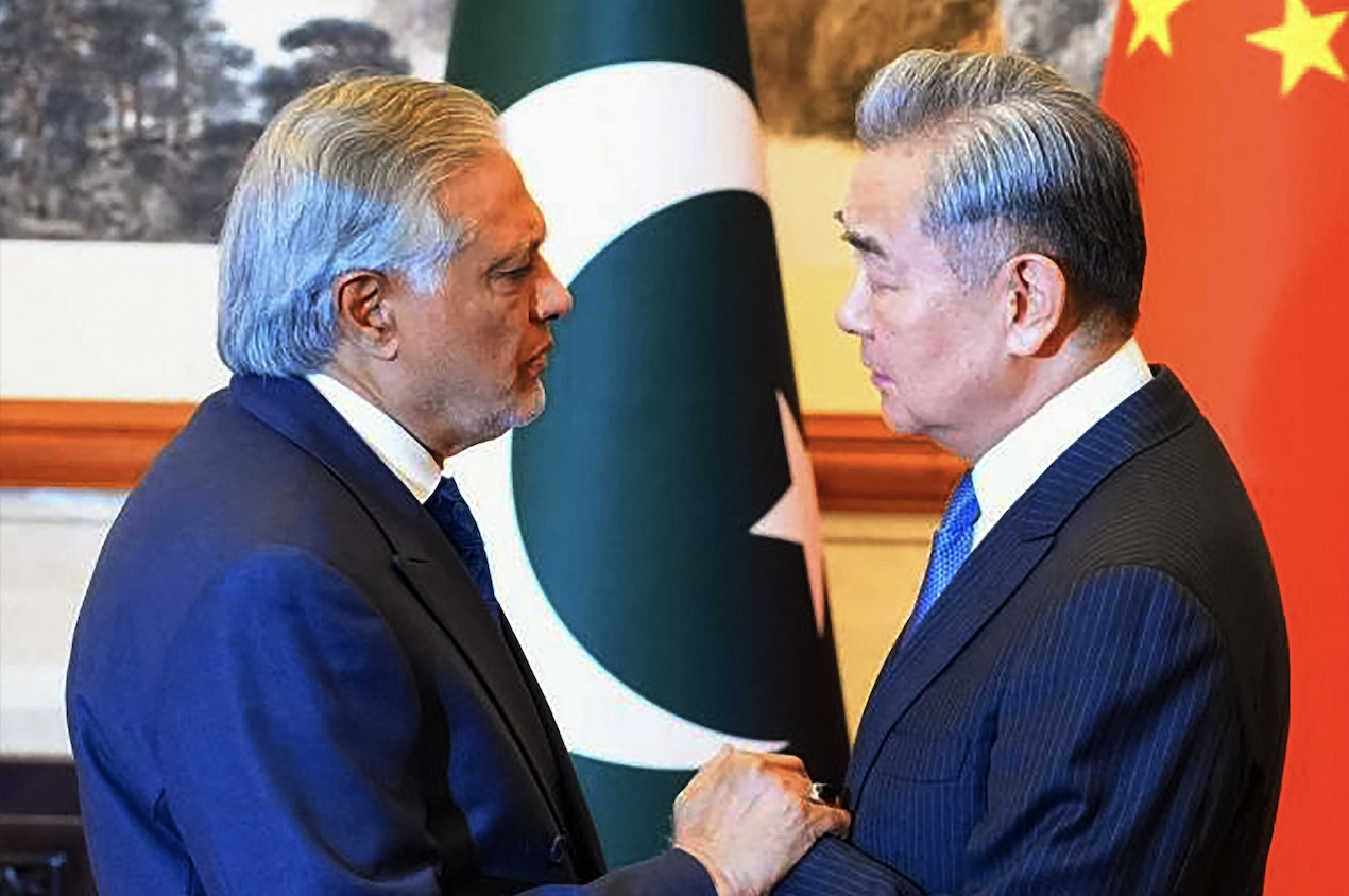This handout photograph taken on March 31, 2026 and released by Pakistan's Ministry of Foreign Affairs shows China's Foreign Minister Wang Yi (R) greeting his Pakistani counterpart Ishaq Dar in Beijing. (Pakistan's Ministry of Foreign Affairs/AFP)