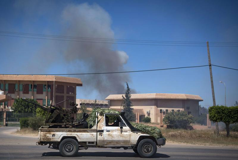 Smoke rises above buildings in Espiaa, about 40 kilometers (25 miles) south of the Libyan capital Tripoli. (AFP/File)