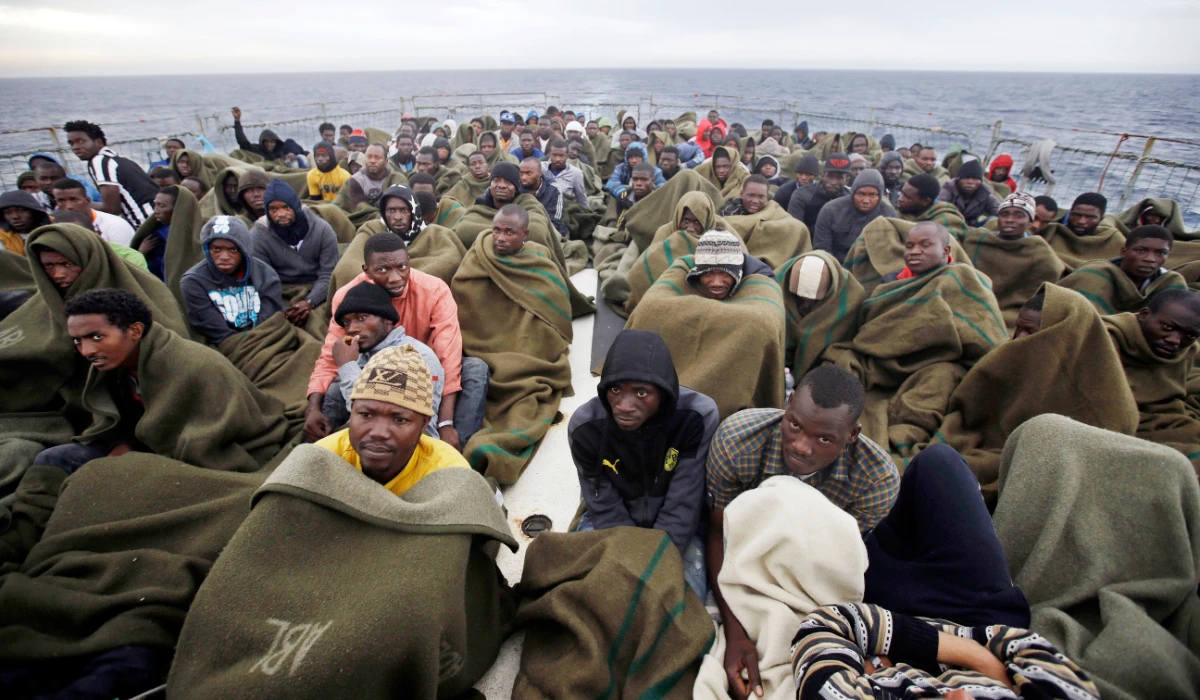 Migrants sit on the deck of the Belgian Navy vessel Godetia after they were saved at sea during a search and rescue mission in the Mediterranean Sea off the Libyan coasts, Wednesday, June 24, 2015. (AP)