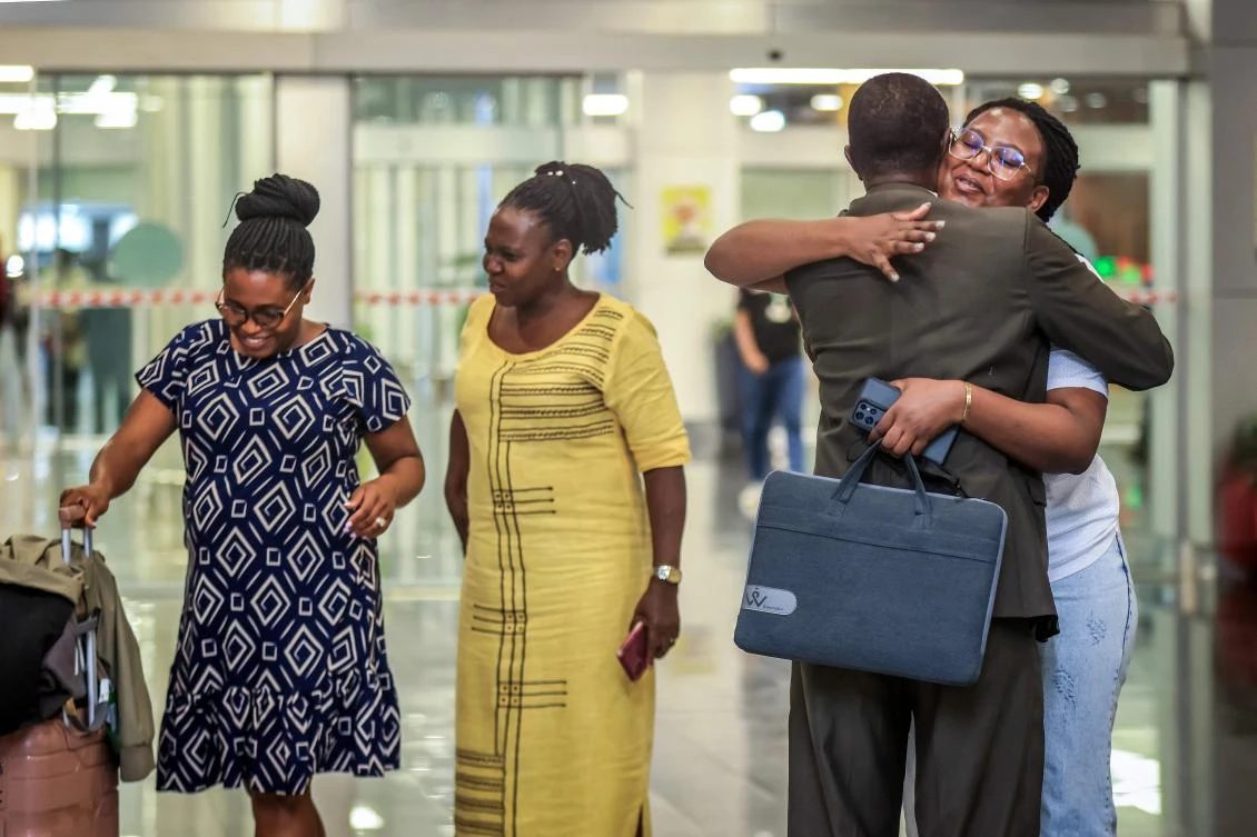 Ugandan students evacuated from Iran are welcomed by their families after arriving from Turkiye at Entebbe International Airport in Entebbe, March 5, 2026. (AFP)