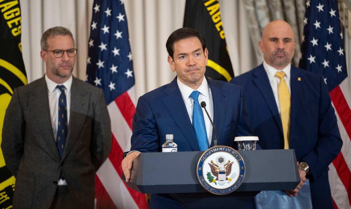 Secretary of State Marco Rubio, center, speaks during a US Hostage and Wrongful Detainee Flag Raising ceremony with Adam Boehler, White House presidential envoy for hostage affairs, left, and FBI Deputy Director Christopher Raia, right, at the State Department, Monday, March 9, 2026 in Washington. (AP)