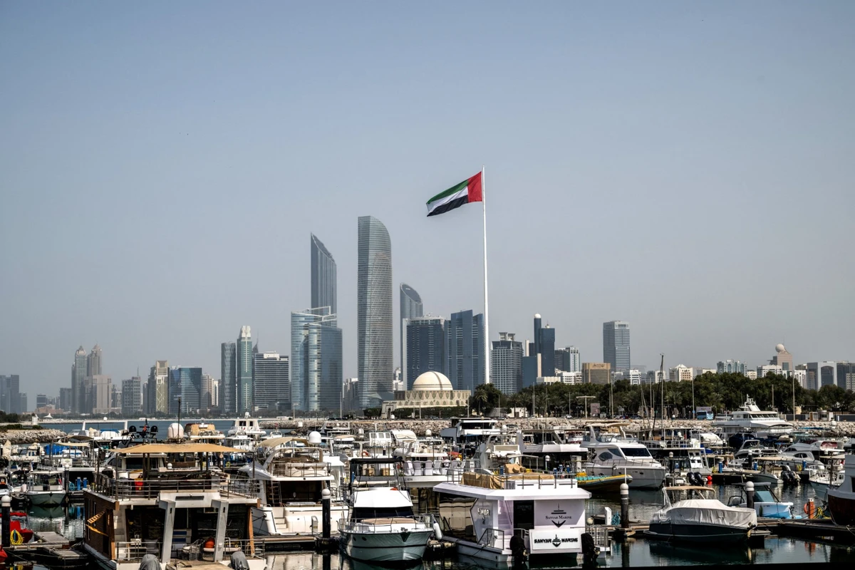 The United Arab Emirates flag flutters against the backdrop of the Abu Dhabi Skyline. (AFP)